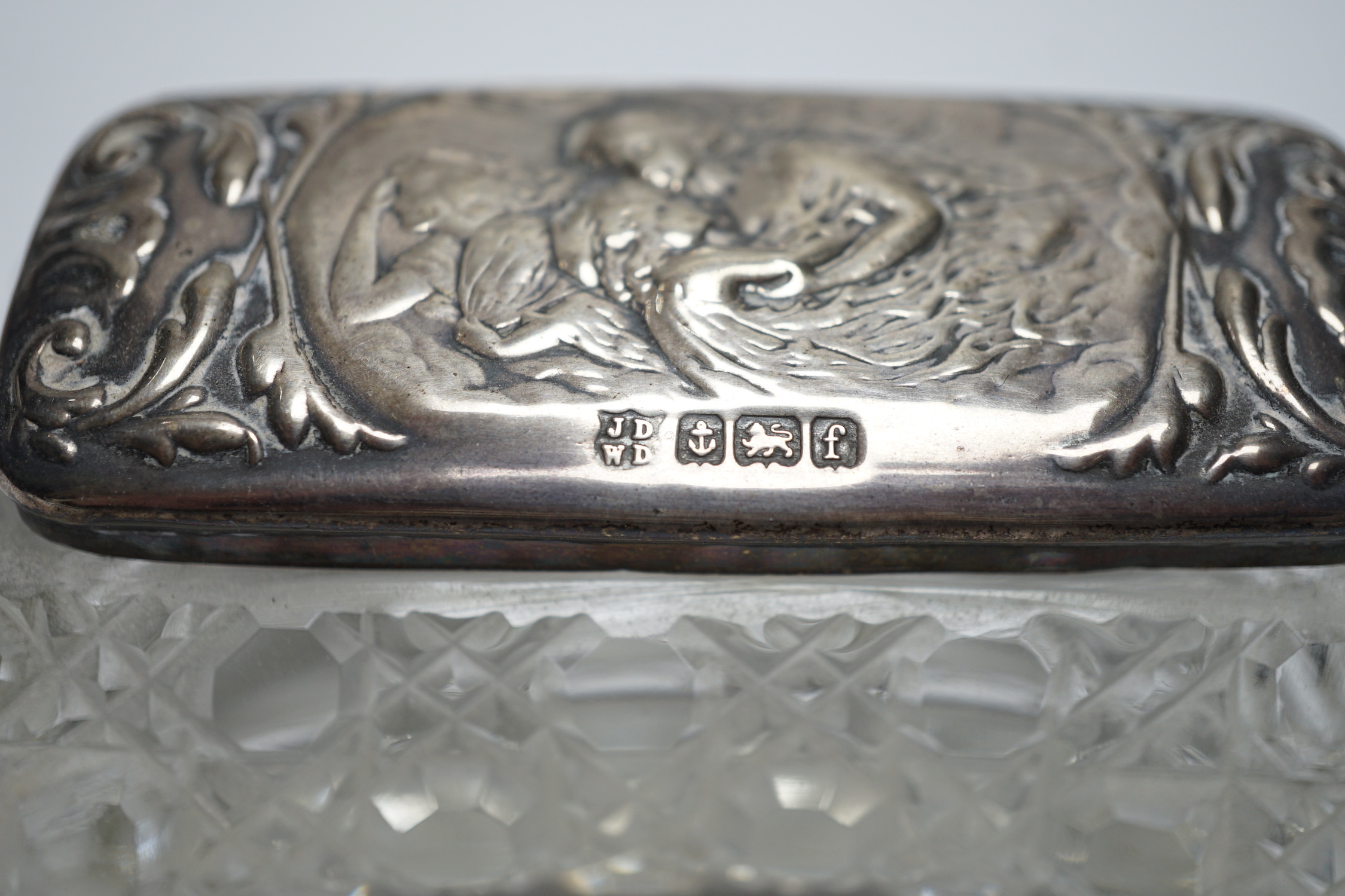 A late Victorian repousse silver mounted travelling pocket watch case, Birmingham, 1898, 11.6cm, with nickel cased pocket watch, together with five silver topped glass toilet jars.